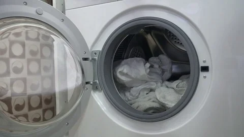 Loading washing machine with clothes Stock Footage 81482183