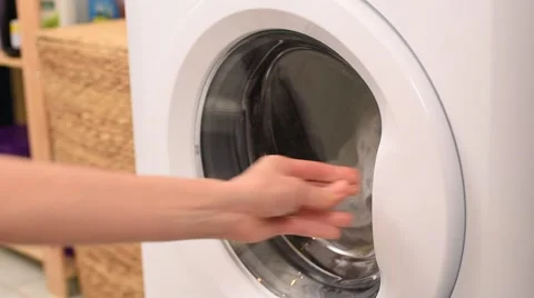 Loading Washing Machine with Dirty Clogthing by Woman Hand Stock Footage 60033035