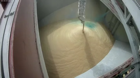 Loading of wheat grain on a ship. Coloring grain with food paint when loading on Stock Footage 154361813