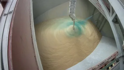 Loading of wheat grain on a ship. Coloring grain with food paint when loading on Stock Footage 154362037
