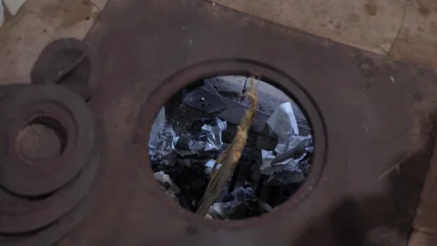 Loading wood chips into a home stove Stock Footage 342867420