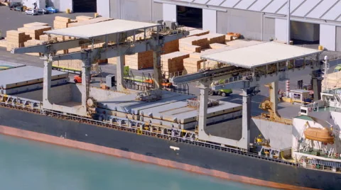 Loading wood products onto a ship in time lapse Stock Footage 54957676