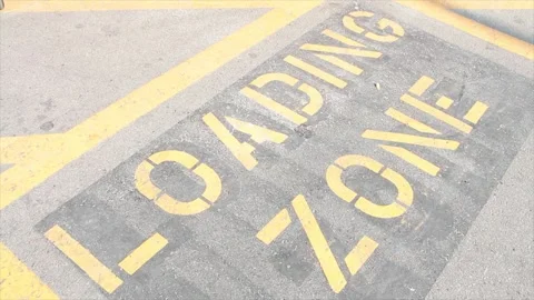 Loading zone writing caption text word in yellow on black on pavement cement Stock Footage 251360940