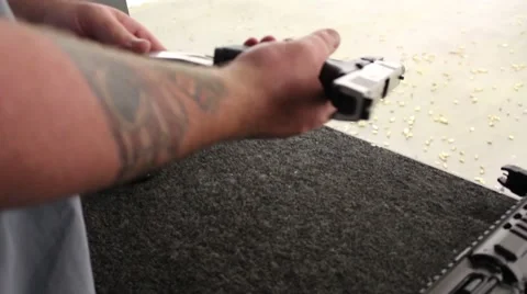 Loading/unloading handgun/firing Video stock 61085630