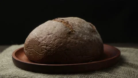 A loaf of black bread on a rotating tray Stock Footage 192921840