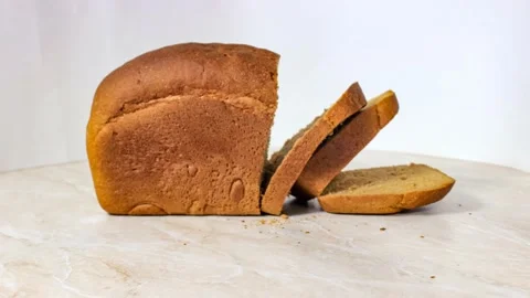 A loaf of black bread, which is cut into chunks. Stock Footage 159673514