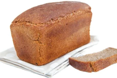 Loaf of bread and slice on doily isolated on white Stock Photos