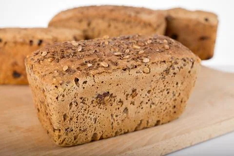 A loaf of bread on the background of cutting boards and other bread Stock Photos