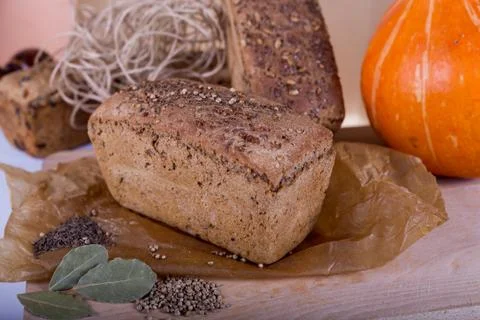 A loaf of bread on the background of cutting boards and other bread and pumpk Stock Photos