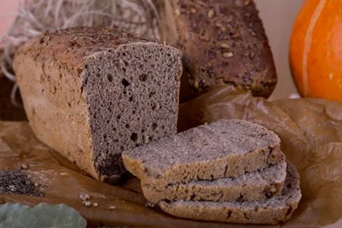 A loaf of bread on the background of cutting boards and other bread and pumpk Stock Photos