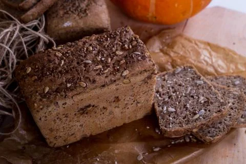 A loaf of bread on the background of cutting boards and other bread and pumpk Stock Photos