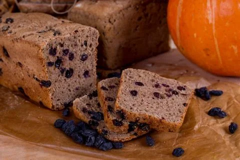 A loaf of bread on the background of cutting boards and other bread and pumpk Stock Photos