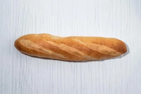 Loaf of bread baguette on white table breakfast food concept. Stock Photos