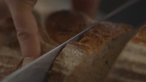 Loaf of bread being sliced with knife Stock Footage 194478475