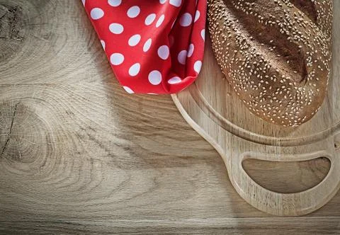 Loaf of bread chopping board tablecloth on wooden background 스톡 사진