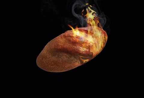 Loaf of bread on fire on a black background Stock Photos