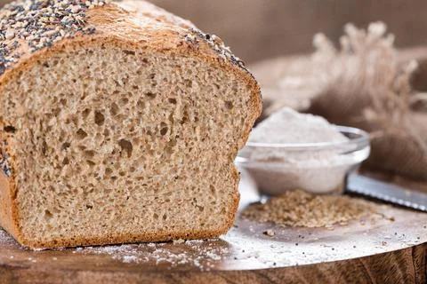 Loaf of bread (fresh baked) on rustic wooden background Stock Photos