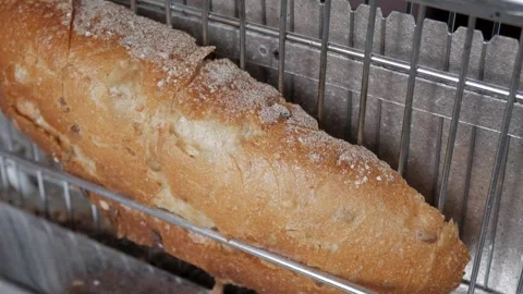 Loaf of bread on metal toaster in a home daily routine setting. Stock-Footage 342935518