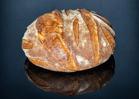A loaf of bread on a shiny table Stock Photos