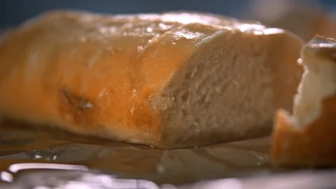 Loaf of bread sitting in a pool of honey Stock Footage 274703140