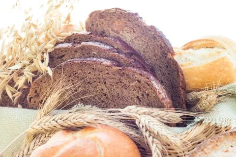 Loaf of bread sliced with crispy rolls Stock Photos
