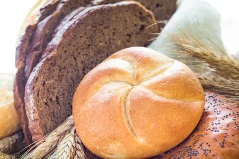 Loaf of bread sliced with crispy rolls Stock Photos
