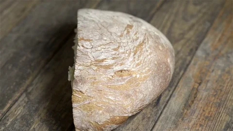 Loaf of bread spinning on wooden table Stock Footage 71358895