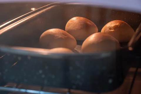 Loaf of bread stuffed inside oven with deliscouse look and brown topping Stock Photos