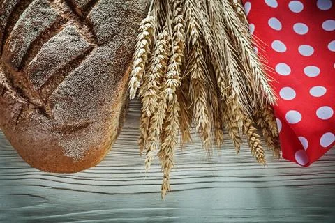 Loaf of bread Wheat ears red dotted tablecloth on a white table 写真素材