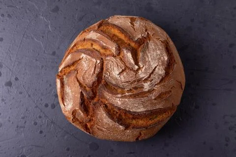 Loaf of brown bread on tone surface Stock Photos