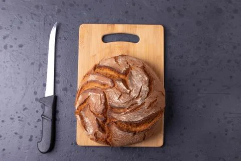 Loaf of brown bread on tone surface Foto stock