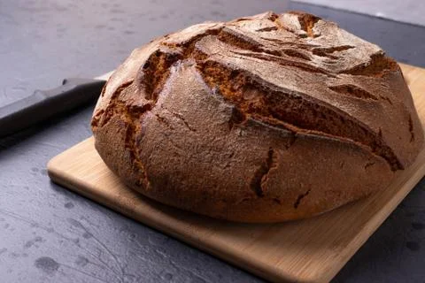 Loaf of brown bread on tone surface Stock Photos