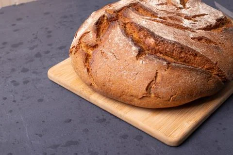 Loaf of brown bread on tone surface Stock Photos