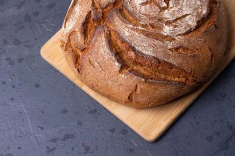 Loaf of brown bread on tone surface Stock Photos