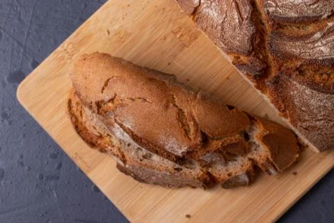 Loaf of brown bread on tone surface Stock Photos