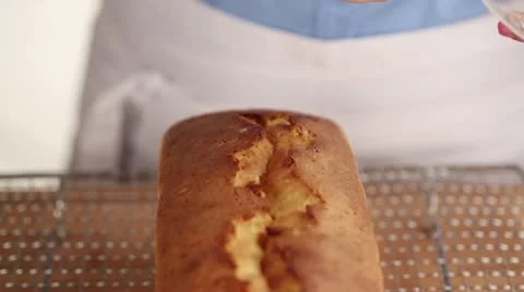 A loaf cake being brushed with icing sugar Stock Footage 24657176