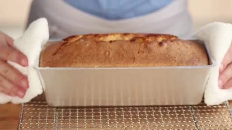 A loaf cake being turned out of the tin Stock Footage 24657169