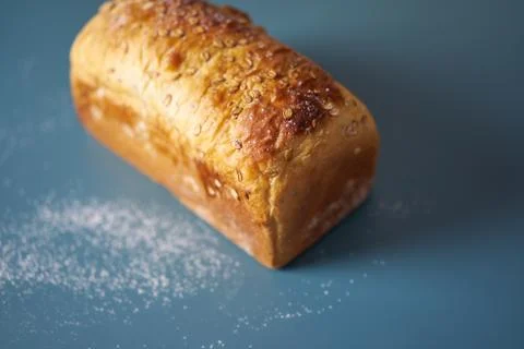 A loaf of fresh bread lying on colored surface Foto stock
