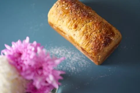 A loaf of fresh bread lying on colored surface Stock Photos