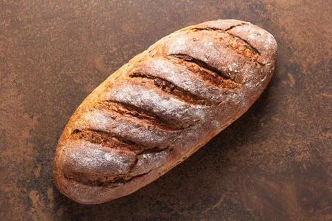 Loaf of fresh bread on table Stock Photos
