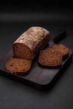 Loaf of fresh crispy brown bread with grains and seeds Foto stock