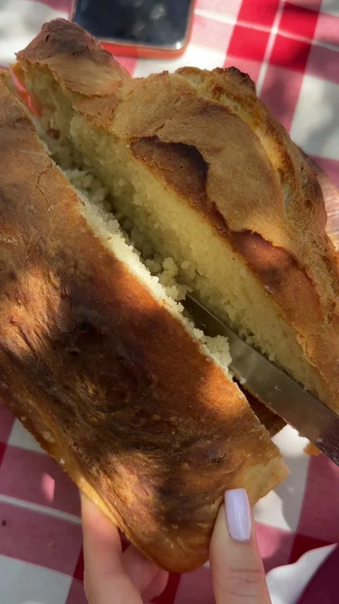 Loaf of freshly baked bread cut in half and separated 스톡 동영상 277872133