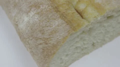 Loaf of freshly baked wheat bread rotate on a white background Stock Footage 131074407