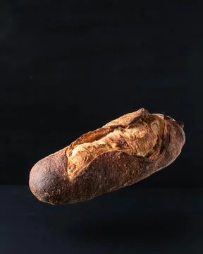 A loaf of gray bread with figs hung in the air. Stock-Fotos