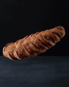 A loaf of gray bread with figs hung in the air. Stock Photos