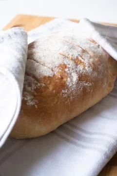 A loaf of homemade fresh bread with flour sprinkled on top Stock Photos