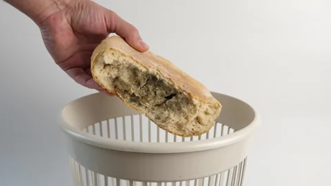 A loaf of moldy bread is thrown into the trash. Disposal of bread. Stock Footage 299834057