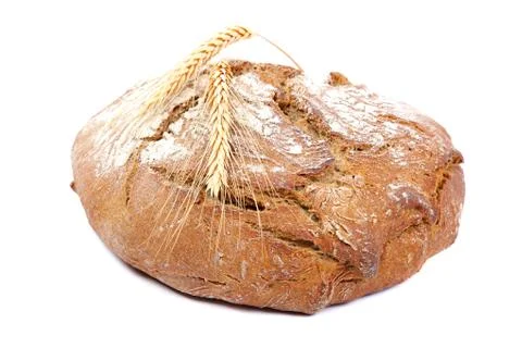Loaf of rye bread and wheat ears. Stock Photos