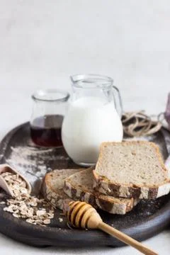 Loaf of sliced rye bread on old wooden tray. Stock Photos