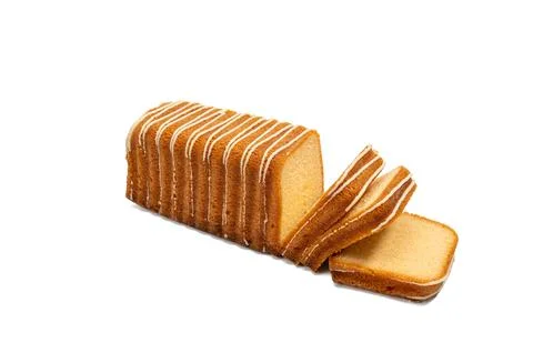 Loaf sponge cake with white icing stripes, partly sliced to show soft texture, Stockfoto's
